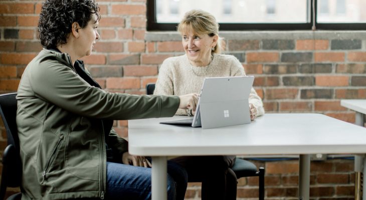 Two people working and talking together